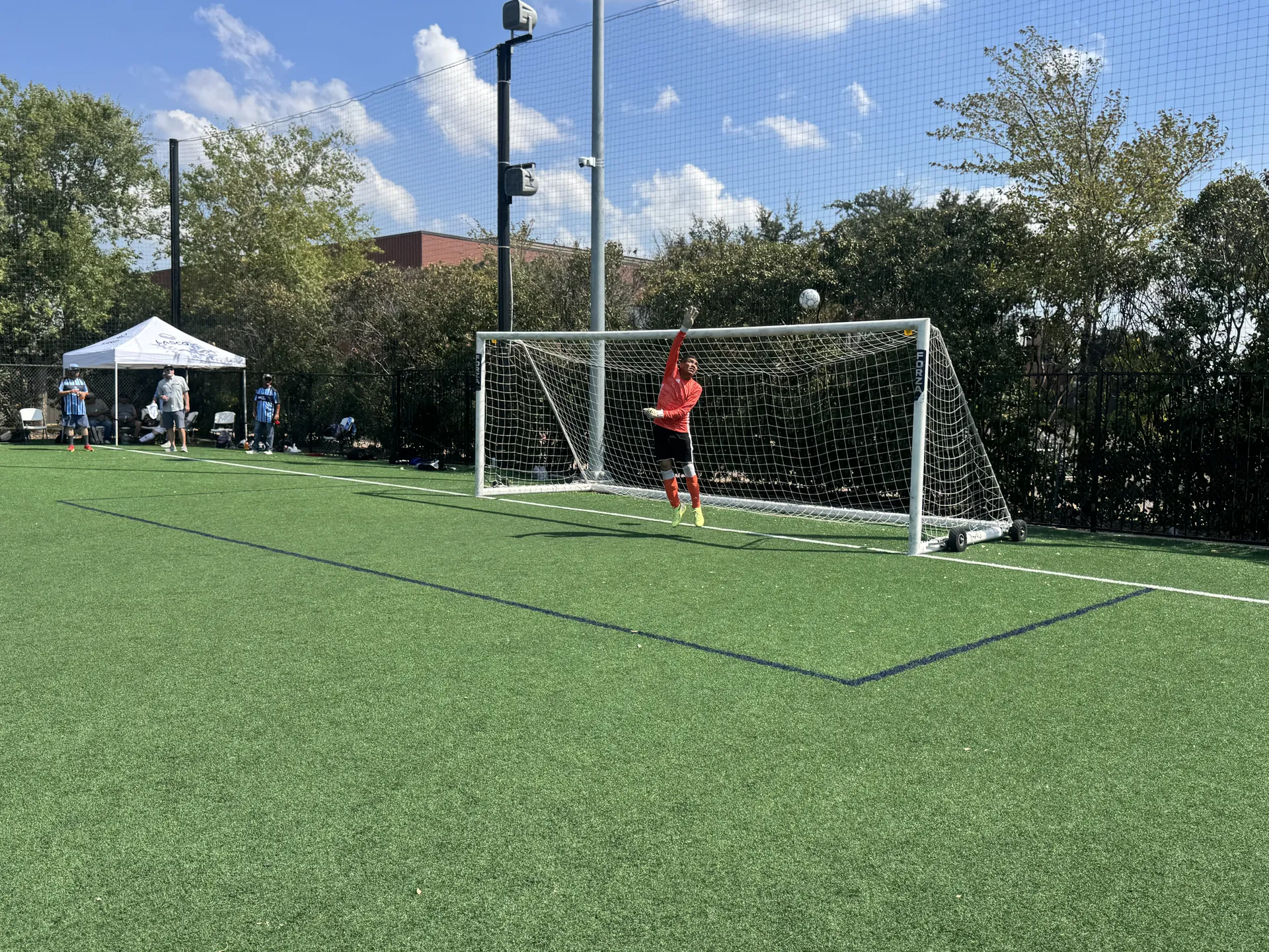 Goalkeeper making a save on the outdoor field