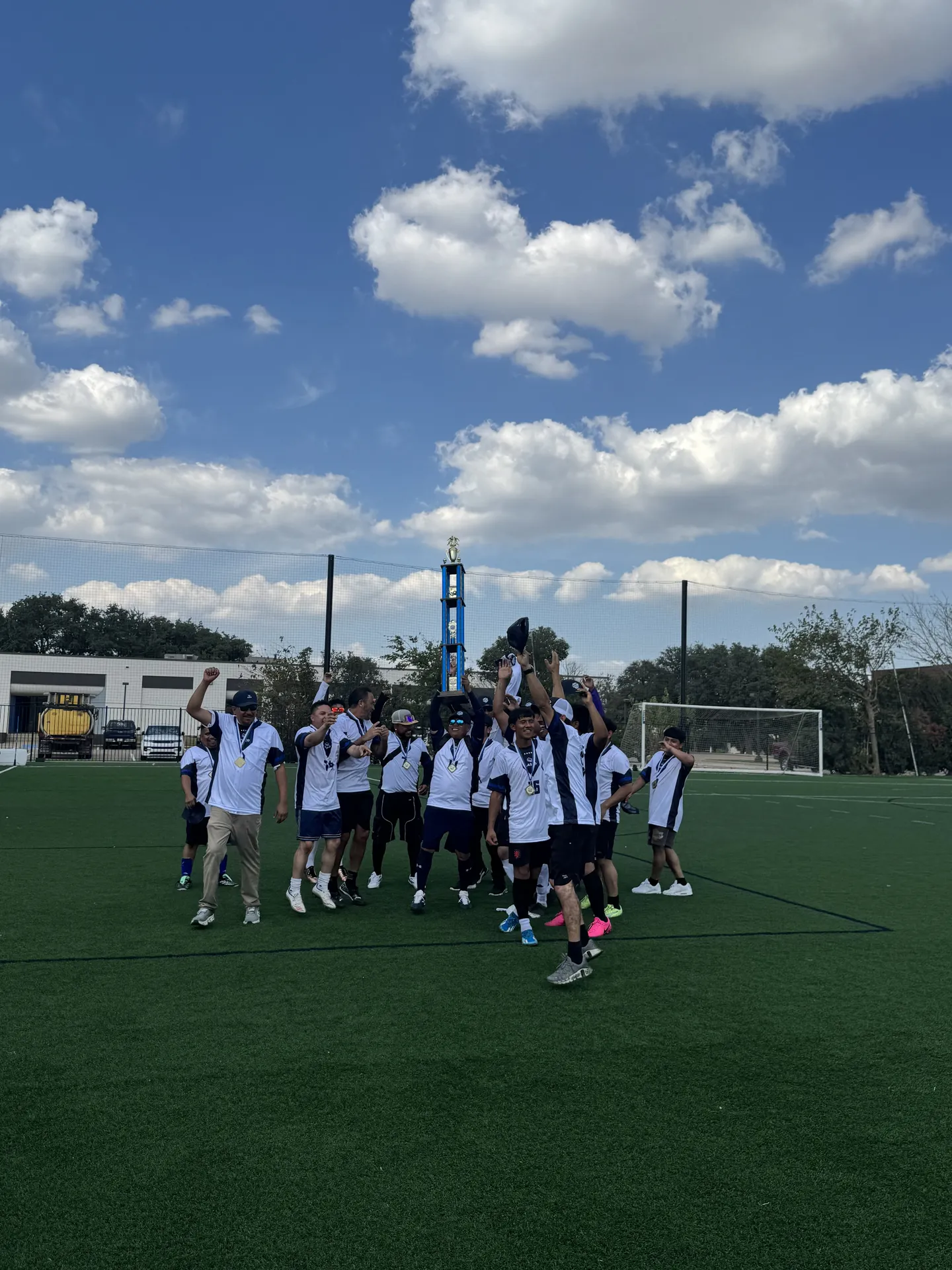 Players celebrating with a tournament trophy